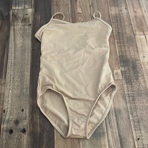 This is a tan leotard from Balera. Size MC.